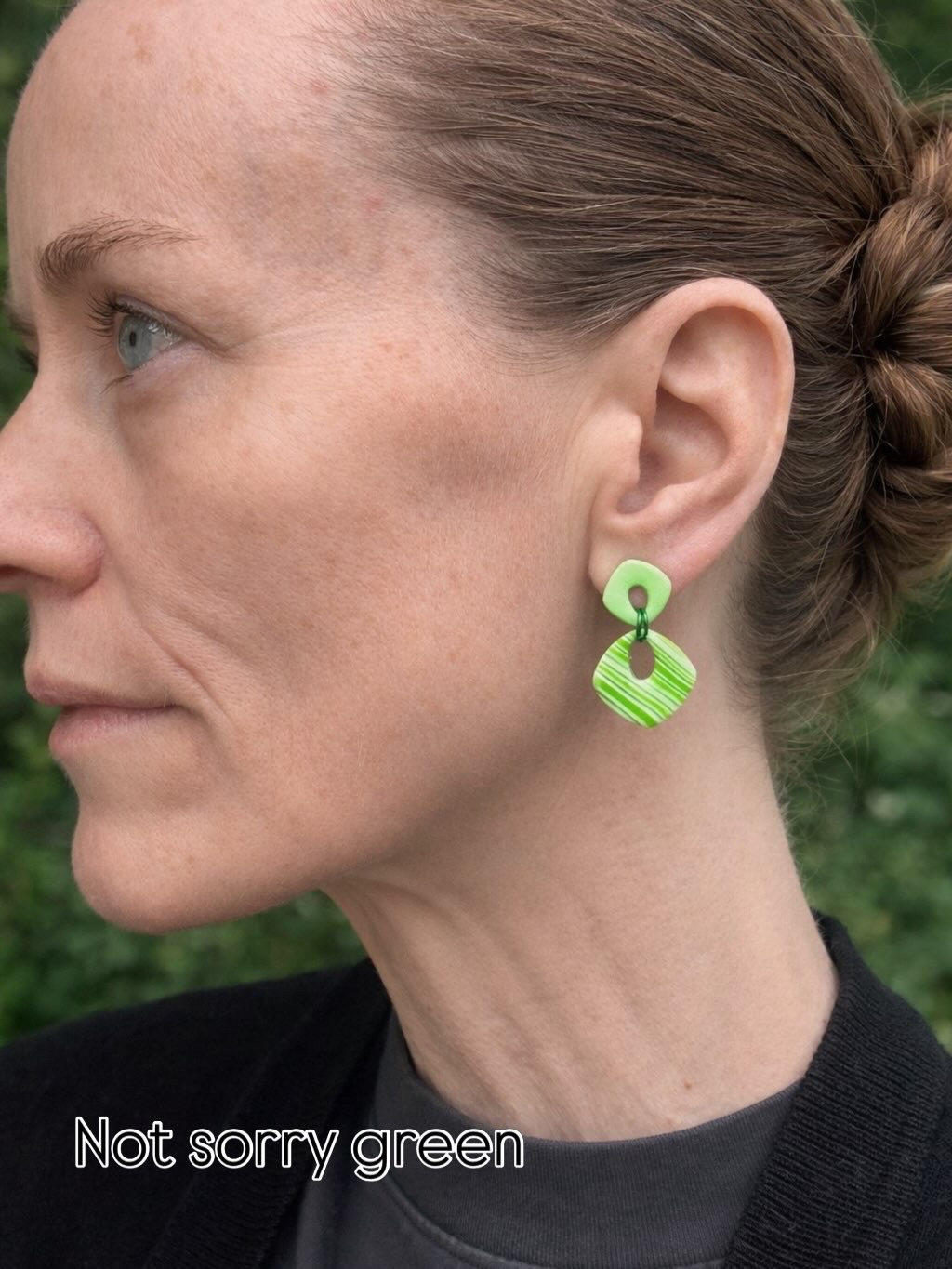 Woman wearing a green striped Monopops earring